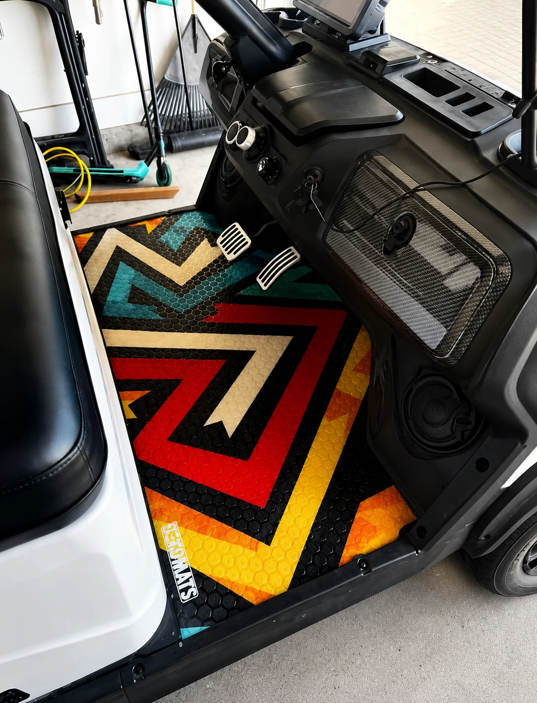 Colorful custom fitted floor mats installed in a white golf cart